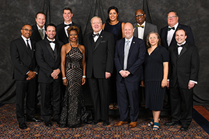 Ohio University President M. Duane Nellis (front center) is pictured with the 2019 Alumni Awards recipients. They are (front, from left) Abdul Williams, BSC ’94; Ryan Kyes, BBA ’02, MBA ’03; Mona Miliner, BSH ’92, MHA ’94; Kyle Kondik, BSJ ’06; Elizabeth Campbell, MFA ’97; Jeffery Baran, BA ’98, MA ’98; (back, from left) Garry Hunter on behalf of his brother, Larry Hunter, BSED ’71, MED ’73; retired Brig. Gen. Mark Arnold, BSISE ’82; Julia Winkfield Stover, BSRS ’06; Anthony Webb, BSC ’76; and William Axline, BBA ’71.