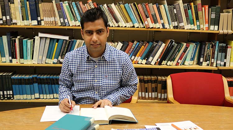 Nepalese student Bishal Bhattarai studies in the library