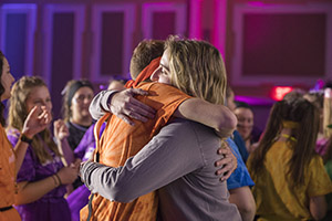Luc Messenger and Becca Marra, members of the BobcaThon 2019 leadership team, hug after hearing the announcement that the year-long fundraiser had generated more than $110,000 for Ronald McDonald House Charities of Central Ohio. Photo by Max Catalano, BSVC ’20