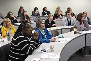 A packed room listens as Jennifer Bennett, director of Ohio University’s WellWorks, presents “Resilience and Thriving: The Secret Power of Stress.”