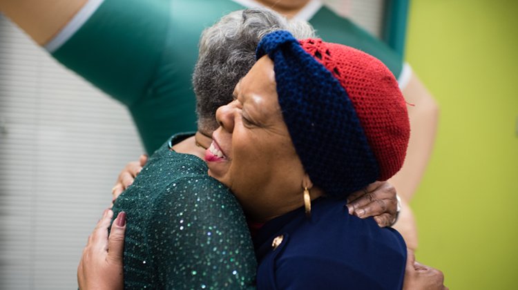 Two Ebony Bobcat Network members embrace at the February fundraiser