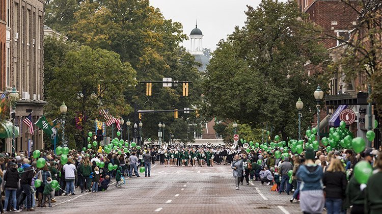 Court Street is lined with green balloons and Bobcat spirit as OHIO’s Marching 110 makes its way along the bricks of Athens during the 2018 Homecoming Parade. 