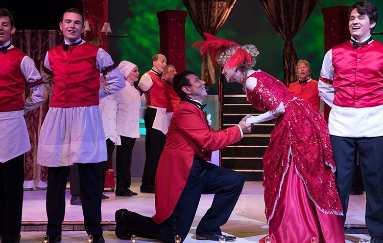 Victor Jones, portraying maître d’ Rudolf Reisenweber, and Jennifer Myers, performing in the lead role of Dolly Levi, share a moment on stage – their first since high school during the Ohio University Lancaster Theatre’s 2018 community production, “Hello Dolly!”