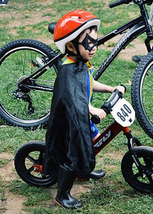 Young child dressed as superhero during On The Green Weekend