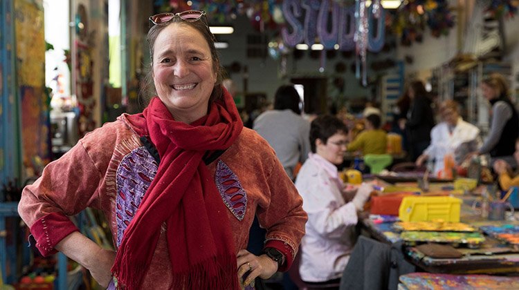 Patty Mitchell, founder and executive director of Passion Works Studio, is all smiles in the collaborative community arts center she opened 20 years ago.