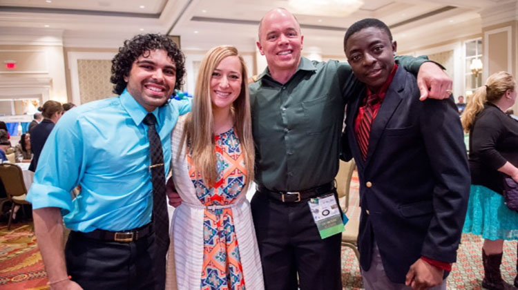 Timothy Law stands with his students