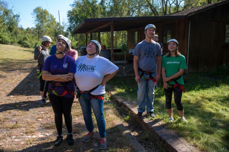 Students and parents watch people zipline on Sept. 30, 2018 at the Challenge Course at The Ridges. Photo by Hannah Ruhoff