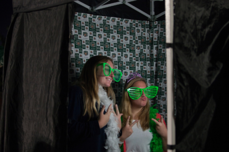 Two students pose for a photo in a photo booth at the 2016 Yell Like Hell Pep Rally.
