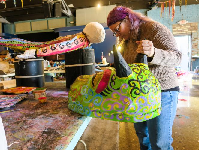 Artist Logan Madison works on a piece for the 2019 Honey for the Heart parade. Photo by Alaina Bartel