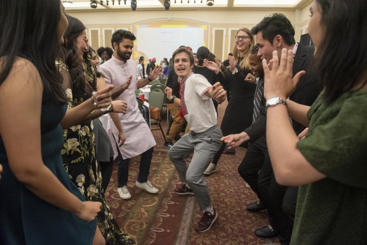 Ohio University community members dance with each other after the International Dinner during International Education Week. The International Dinner included food and performances from around the world. Photo by Hannah Ruhoff