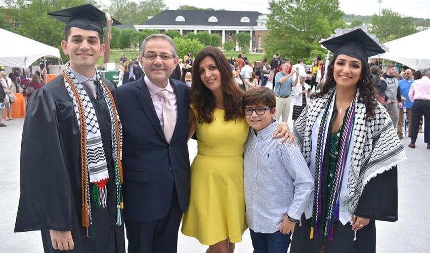 The Afyouni family poses outside the Convocation Center on graduation day for Nader, BBA ’19, and Amal, BA ’19.