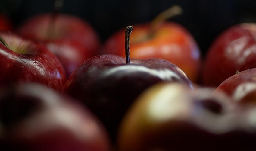 Apples are arranged on a table.