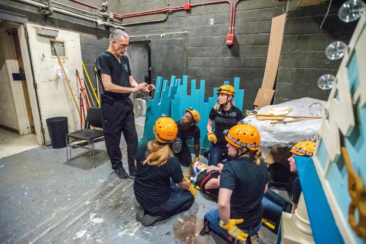 Jeff Russell talks to students backstage during a SHAPe Clinic exercise