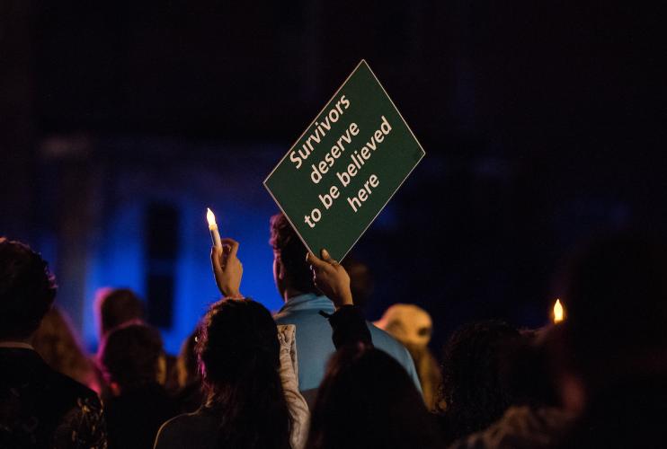 Individuals attending and holding sign at Take Back the Night march 2018