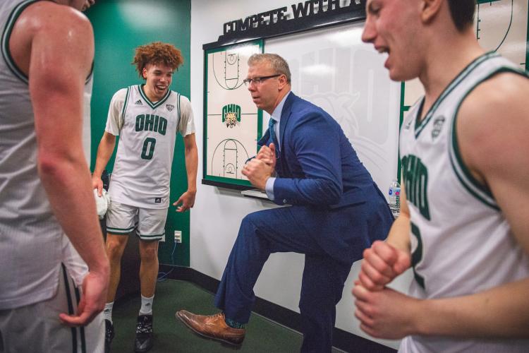 Coach Jeff Boals and basketball players dancing