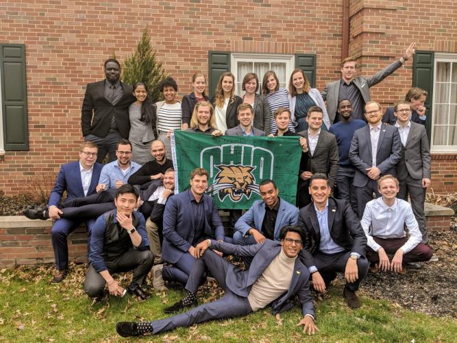 Participants in the Sogeti Netherlands Young Professional Development Program hold up an OHIO flag.