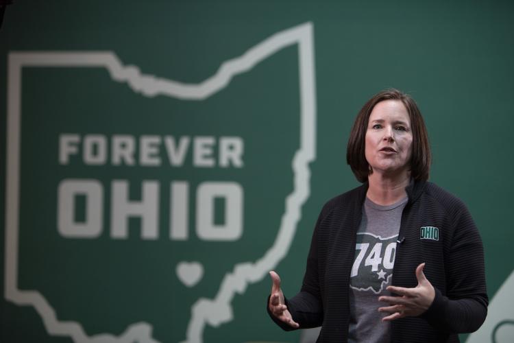 Jenny Hall-Jones speaks at the Leadership Awards ceremony in front of a graphic of the state of Ohio with the words Forever OHIO