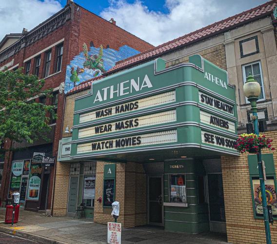 Athena Cinema in Athens, with marquee reading "Wash Hands - Wear Masks - Watch Movies"