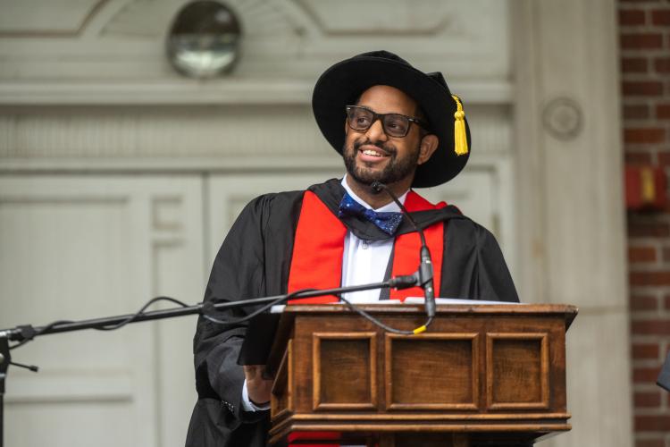 Keith Hawkins smiles at the podium as he gives a speech during the Class of 2020 commencement