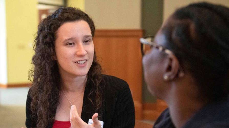 Two women talking in the college of business