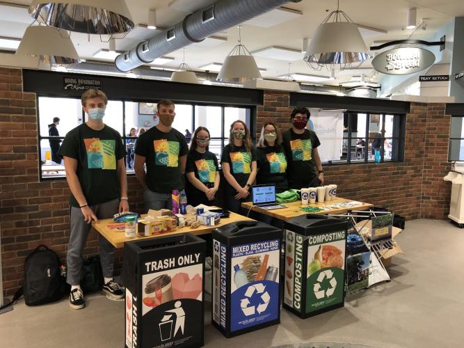 A group of Climate and Sustainability Ambassadors by recycling bins