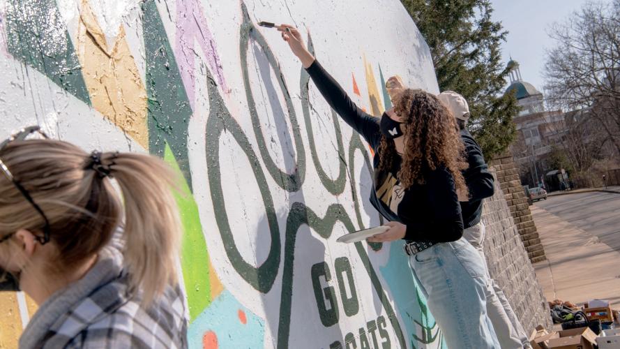 OHIO students are shown painting the Graffiti Wall