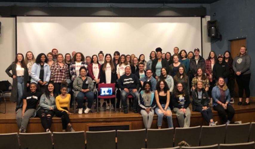 OIP-u students pose on stage in 2019