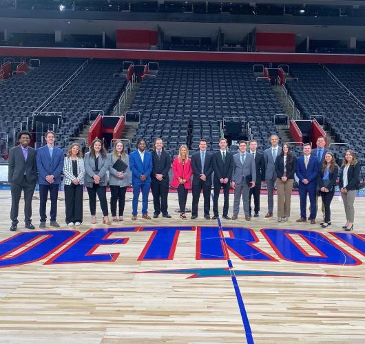 A group of Ohio University students stand together on the Detroit Pistons' court