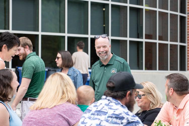 Terry Hogan speaks with colleagues