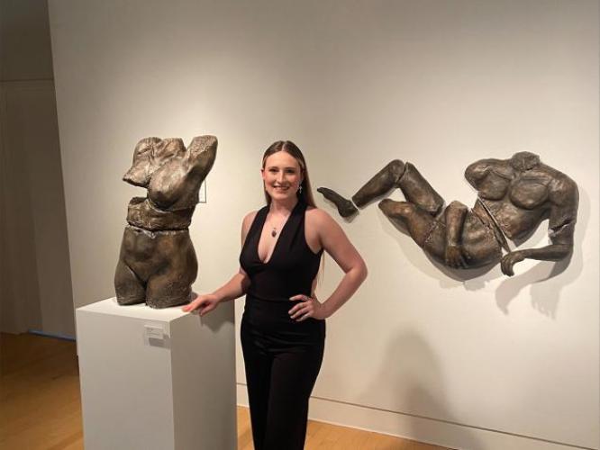 Ceramics Student Jade Lewis with her thesis work in Trisolini Gallery, spring 2022