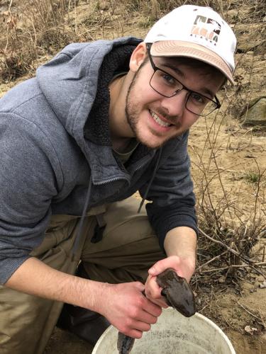 Ryan Wagner with a mudpuppy salamander.