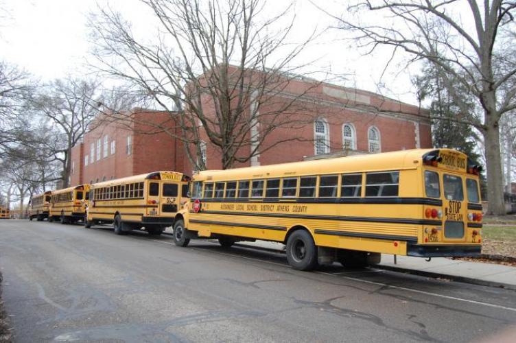 Four yellow buses lined up behind each other