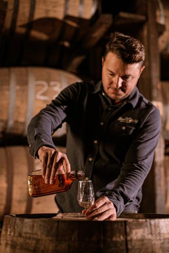 Ian Stirsman pouring whiskey