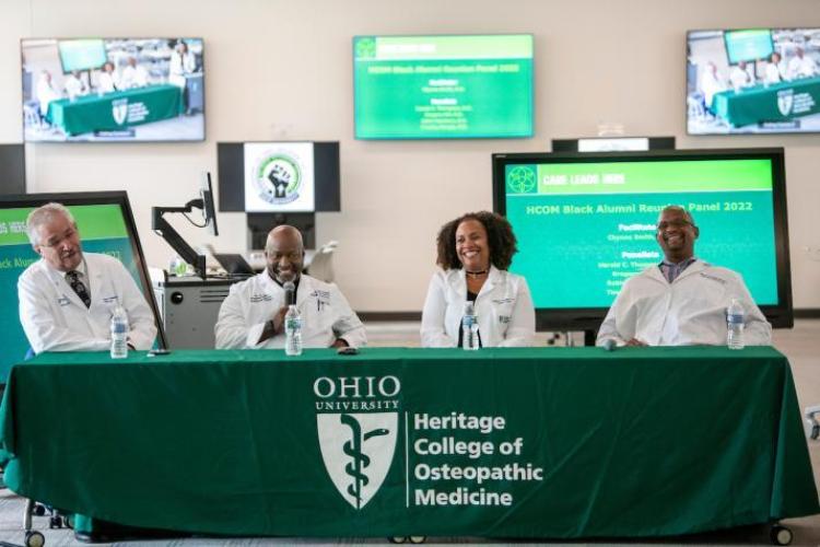 A photo of the alumni panel showing four panelists