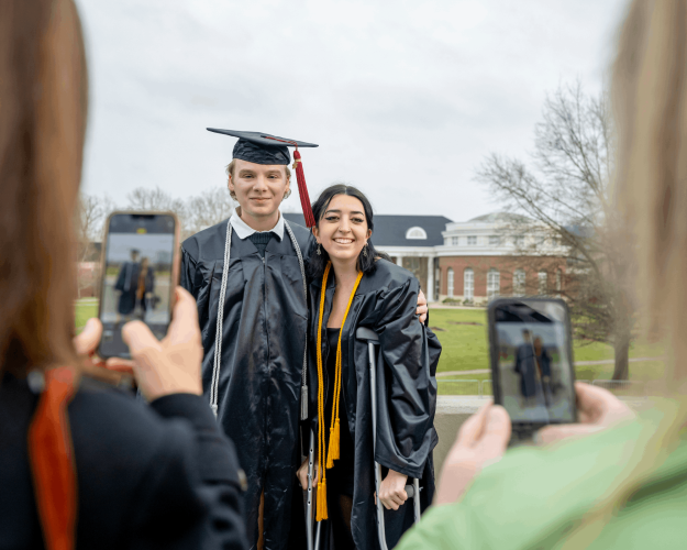 Graduates pose for photos following Fall Commencement.