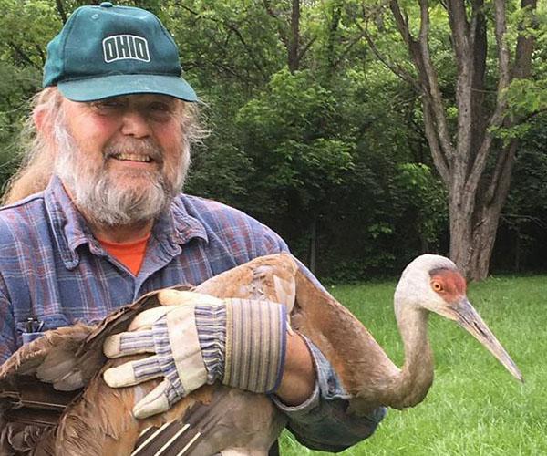 Scott Moody with a Sandhill Crane in 2017.