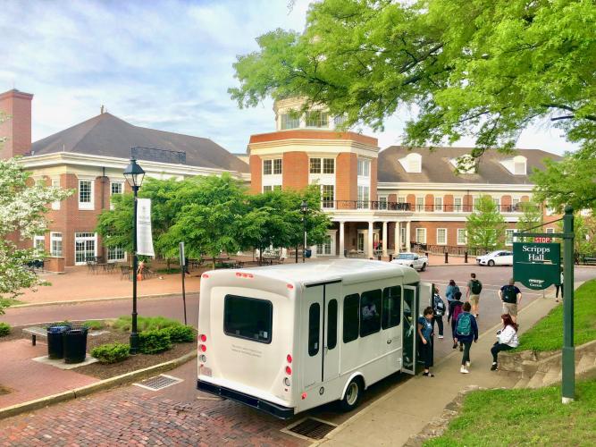 An OHIO Shuttle picks up passengers outside of the Baker University Center