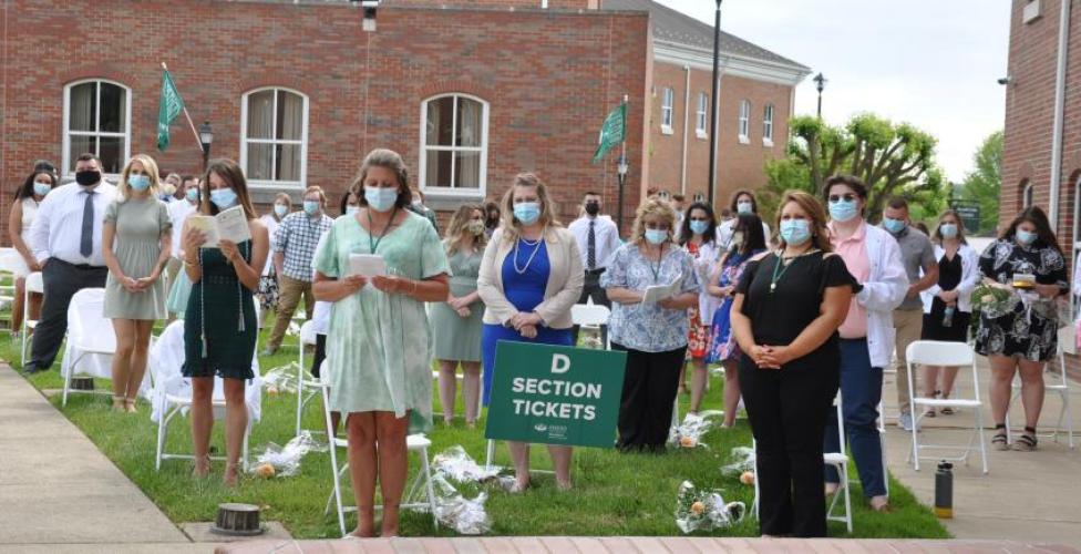 Nursing graduates standing in a courtyard