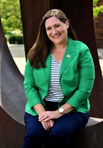 Photo of Stacy Schindler smiling, in a green blazer
