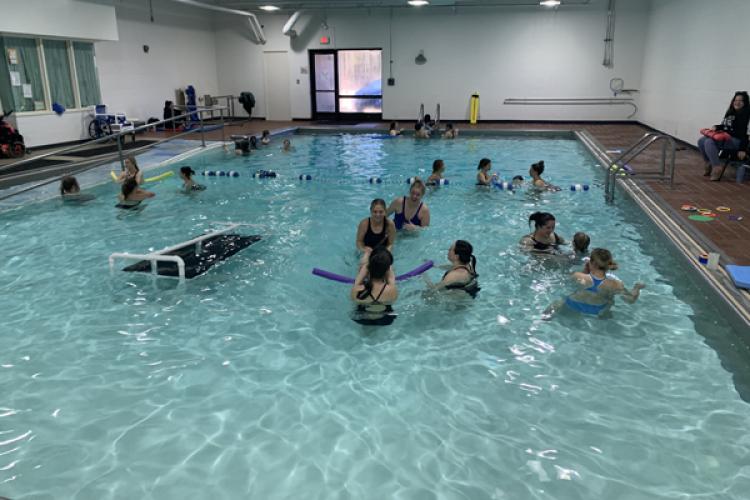 Instructors work with children in the pool at Beacon School.