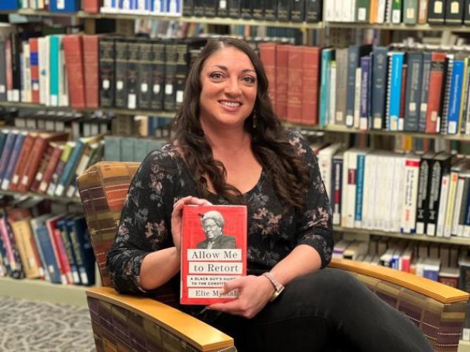 Photo of Kristina Charlotte Estle holding book