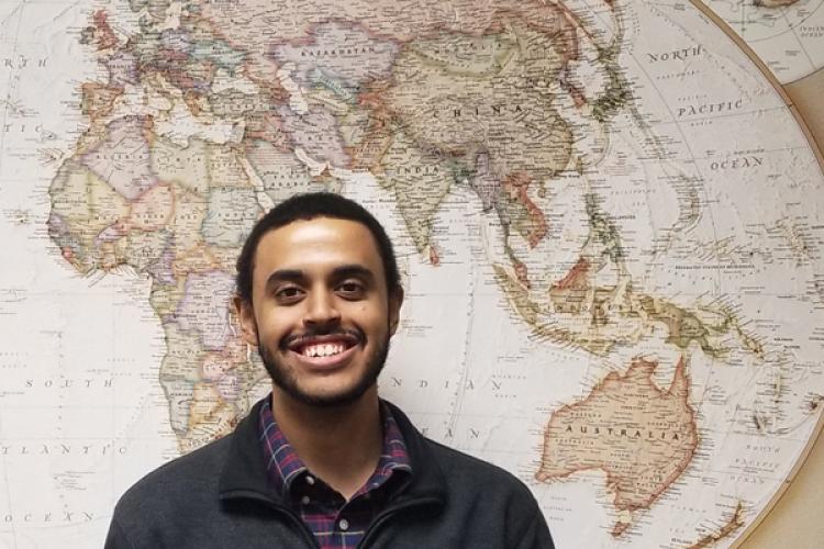 Robert Green, in front of a map of Asia