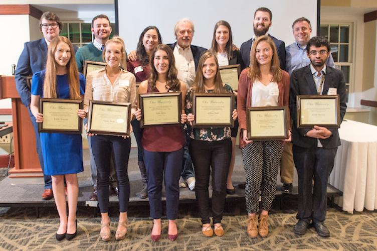 Group of faculty and students holding awards