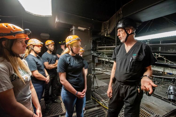 Jeff Russell conducting a theater safety exercise with a group of students