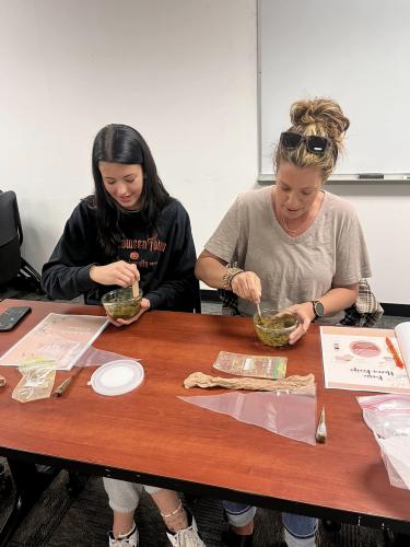 Women mix henna in bowls