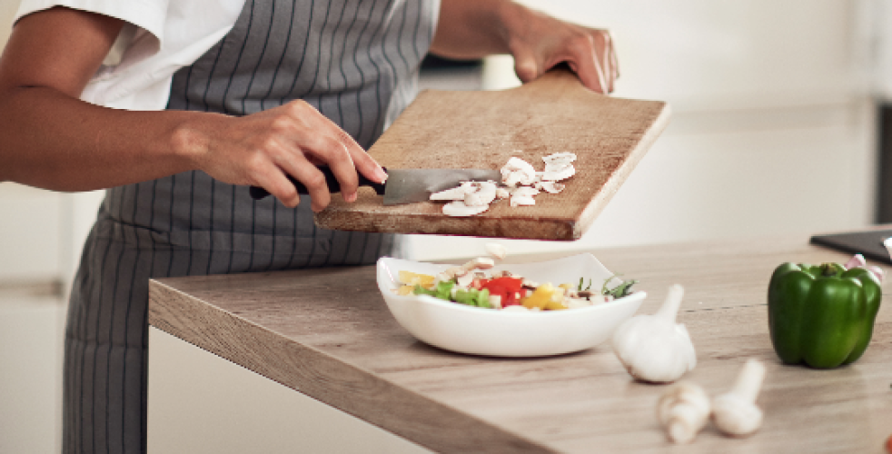 A photo of an individual preparing a meal