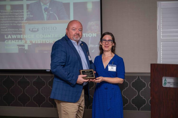 Marty Conley accepting plaque honoring partnership