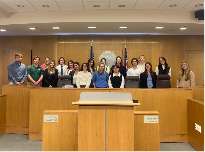 pre-law students pose for photo in courtroom