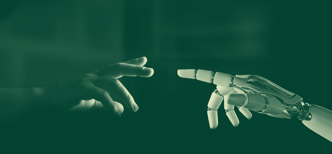 A human hand reaching out to touch a robot hand.