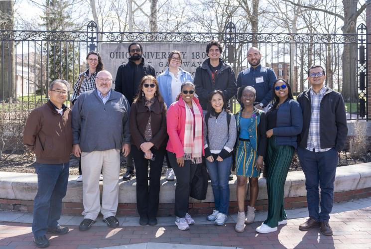 The Hubert H. Humphrey Fellows and several OHIO  representatives pose for a photo at the College Gate